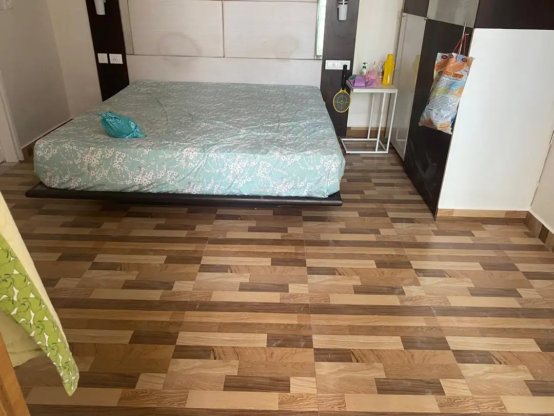 Renovated bedroom with wood-finish floor tiles and built-in wardrobe, Egmore DLF