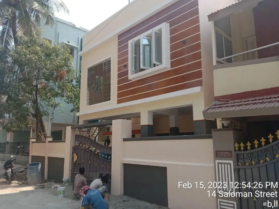Renovated house exterior with timber-texture cladding and a new gate, Selaiyur